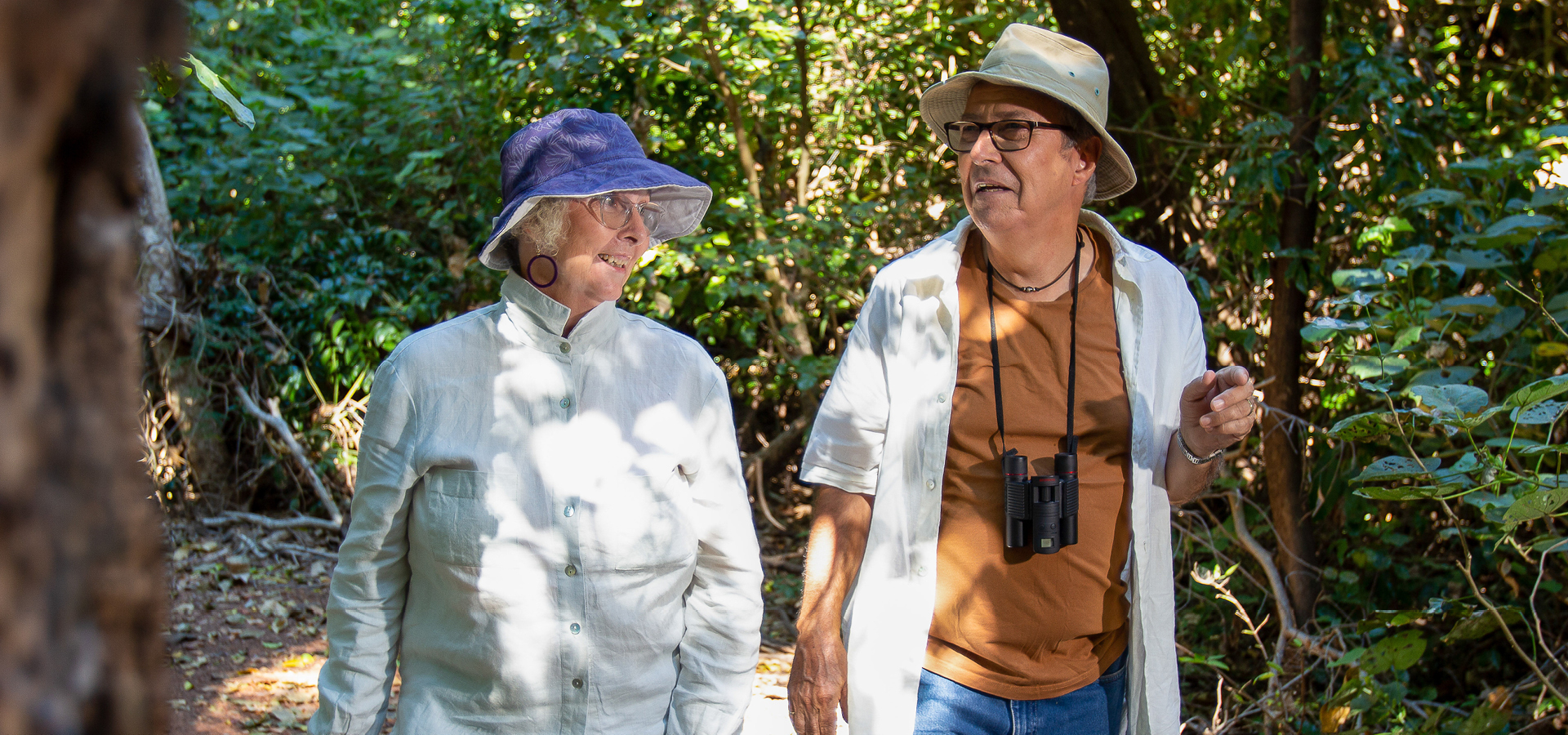 Older couple birdwatching in the Casuarina Conservation Area.
